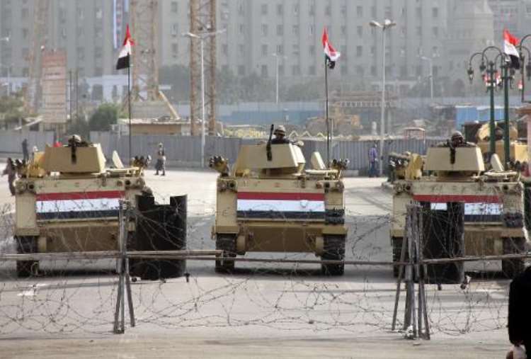 <b>Egyptian military vehicles guard a checkpoint at Tahrir Square in Cairo, on January 26, 2014.  By Ahmed Taranh (AFP/File)</b>