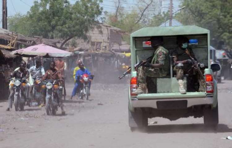<b>This picture taken on April 30, 2013 shows soldiers patrolling the streets of the restive northeastern Nigerian town of Maiduguri.  By Pius Utomi Ekpei (AFP/File)</b>