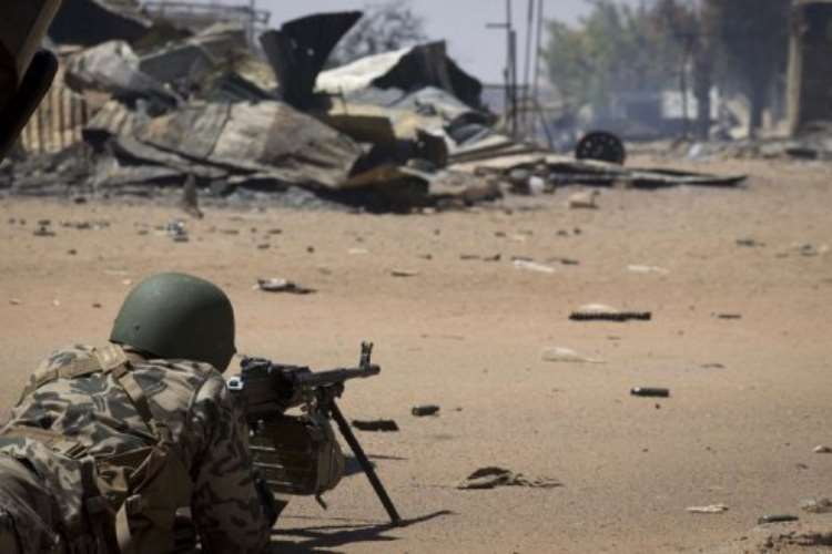 <b>A Malian soldier holds position in front of the courthouse in Gao on February 22, 2013.  By Joel Saget (AFP)</b>