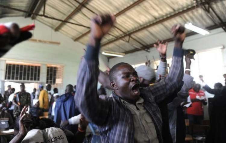<b>A voter celebrates a win for his candidate on March 6, 2013 at a polling station in Nairobi's Mathare slum.  By Simon Maina (AFP)</b>