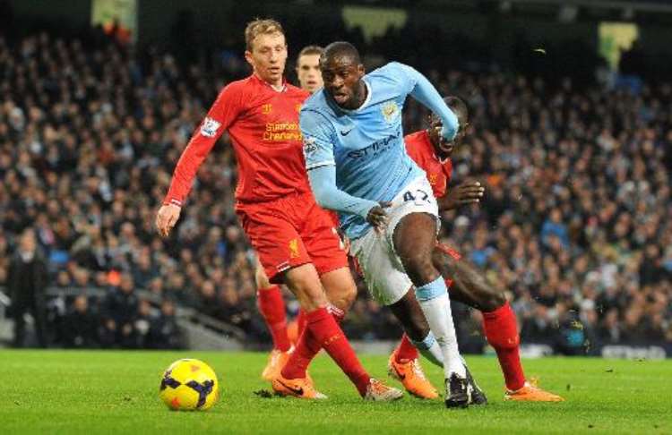 <b>Yaya Toure runs with the ball during Manchester City's Premier league game against Liverpool at Etihad Stadium in Manchester, northwest England on December 26, 2013.  By Paul Ellis (AFP)</b>